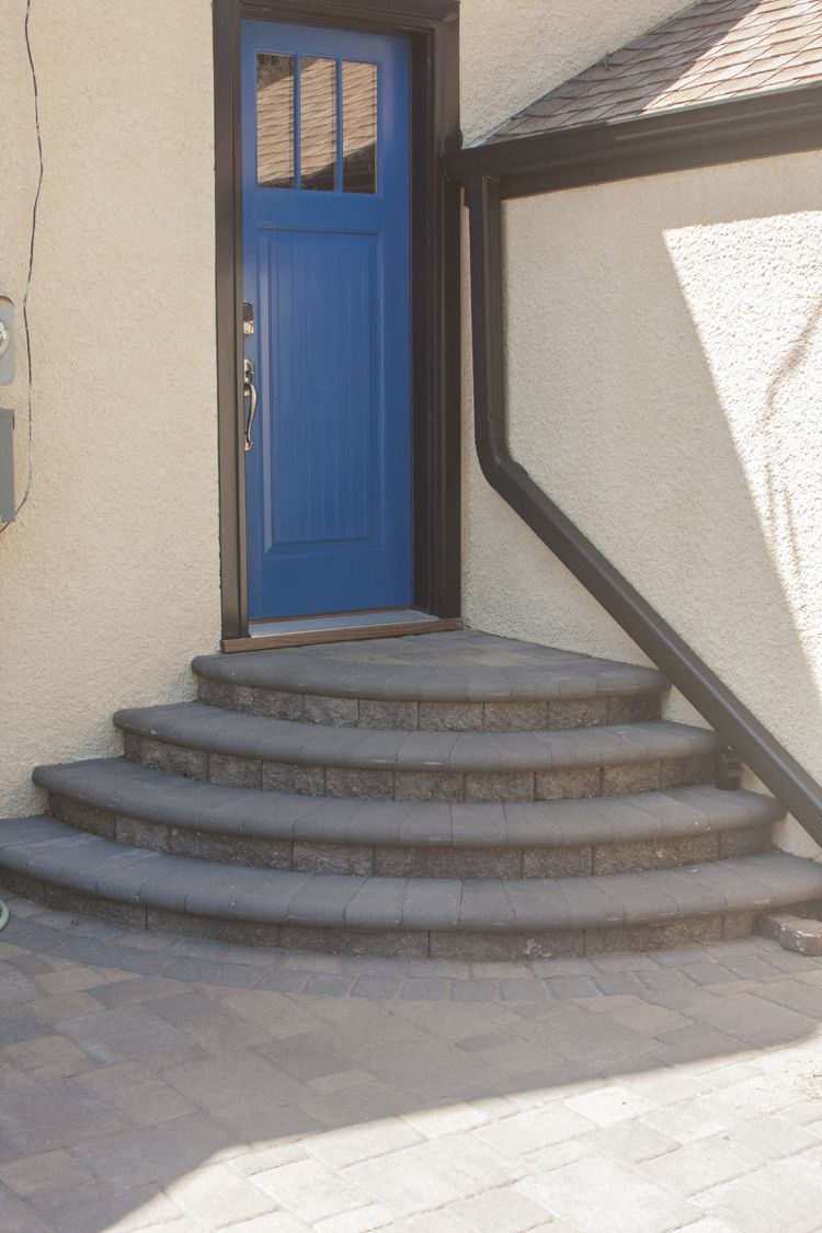 One-piece concrete steps were removed to create a VERSA-LOK pedestal stack staircase, making a stunning entrance to the back door of the home.