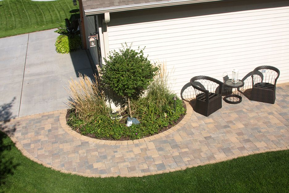 A simple patio and walkway spruce up this residential yard.