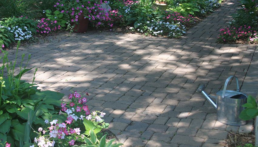 Pavers, flowers and cooling shade make for an inviting patio.