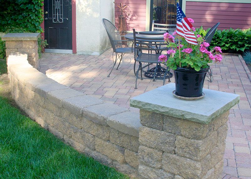 This seat wall and paver patio makes a multipurpose outdoor living space.