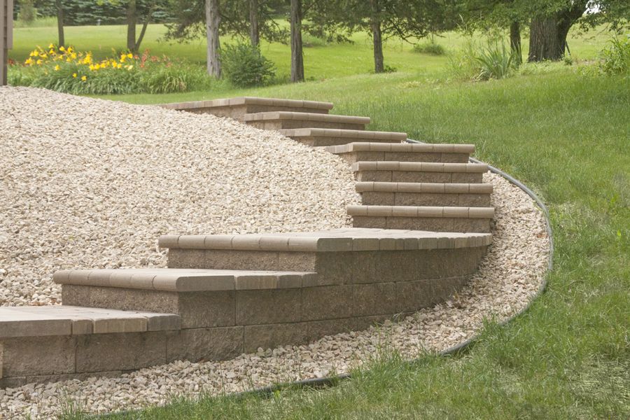 VERSA-LOK retaining wall block can be used to create the base for steps and stairs and is topped with Bullnose pavers.