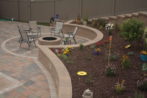A circular patio creates a relaxing area for the fire pit.
