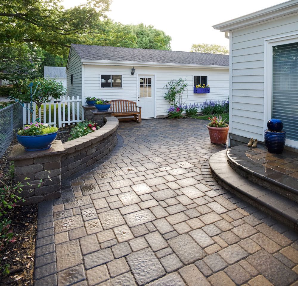 This paver patio and planter seat walls make a small backyard space beautiful and more functional.