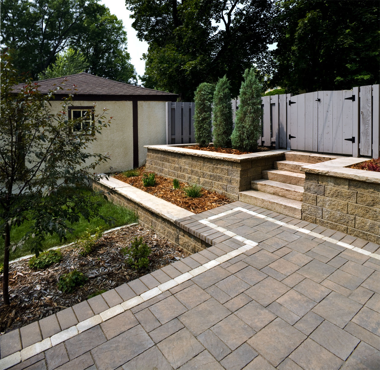 Sit back and relax in your own backyard on a beautiful, maintenance-free paver patio.