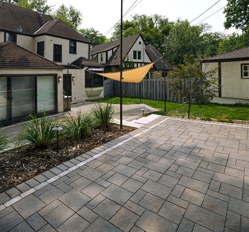 This paver patio has plenty of area for relaxing and dining in the backyard.