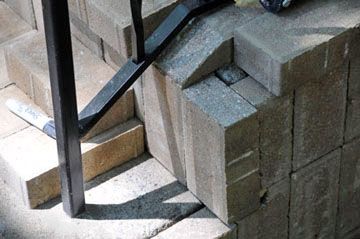 Pavers were cut precisely to accommodate the stair railings.
