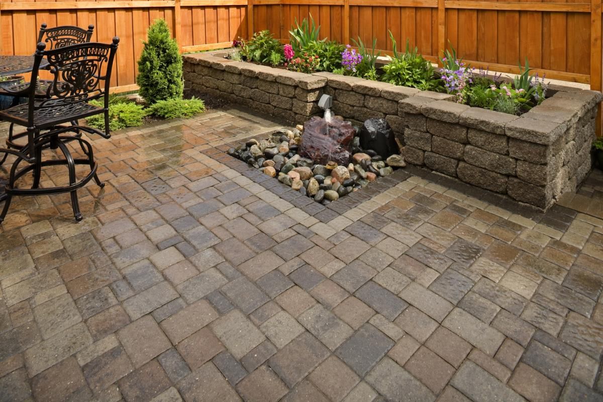 This low- to no-maintenance patio, with its planter and bubbler, is the perfect spot to rest and relax.