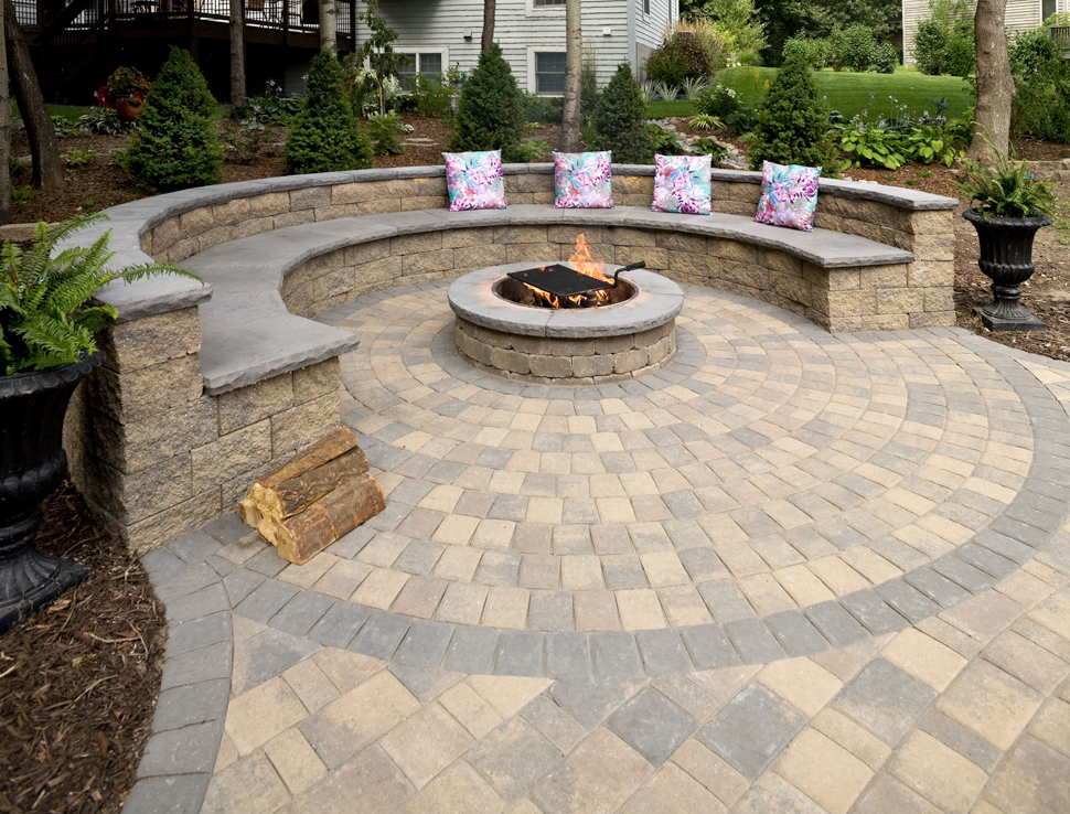 Circular patio with retaining wall two-tier couch around a built-in fire pit